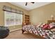 Cozy bedroom featuring a large window, decorative headboard, and a comfortable beanbag chair at 34 Laurel Ne Way, White, GA 30184
