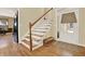 The foyer features wood floors, a staircase, and a view to the front door at 34 Laurel Ne Way, White, GA 30184
