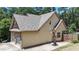 Exterior view of home featuring an attached two-car garage, a basketball hoop, and partial stone facade at 34 Laurel Ne Way, White, GA 30184