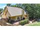 Rear exterior showcasing deck, basketball hoop, and lush greenery, perfect for outdoor enjoyment at 34 Laurel Ne Way, White, GA 30184
