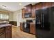 Kitchen with dark wood cabinets and black appliances at 34 Laurel Ne Way, White, GA 30184