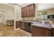 Kitchen with dark wood cabinets and black dishwasher at 34 Laurel Ne Way, White, GA 30184