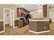 Kitchen with dark wood cabinets, black appliances, and a view of the living area at 34 Laurel Ne Way, White, GA 30184