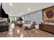 Relaxing living room with a large sectional and wood-look floors at 34 Laurel Ne Way, White, GA 30184
