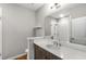 Modern bathroom featuring wood floors, white countertops, and sleek fixtures at 635 Broadview Ne Pl, Atlanta, GA 30324