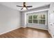Bright bedroom featuring wood floors, a modern ceiling fan, and a large window for natural light at 635 Broadview Ne Pl, Atlanta, GA 30324