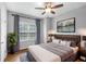 Inviting bedroom featuring a ceiling fan, large windows, and a comfortable bed at 635 Broadview Ne Pl, Atlanta, GA 30324