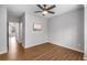 Bedroom featuring wood floors, neutral paint, modern ceiling fan, and hall access at 635 Broadview Ne Pl, Atlanta, GA 30324