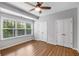 Cozy bedroom with wood floors, neutral paint, a modern ceiling fan, and closet access at 635 Broadview Ne Pl, Atlanta, GA 30324