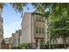 Elegant townhouse exterior with mixed brick, bay windows, and black fence at 635 Broadview Ne Pl, Atlanta, GA 30324