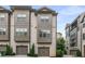 Beautiful townhome with a painted brick exterior, two car garage and manicured landscaping at 635 Broadview Ne Pl, Atlanta, GA 30324