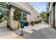 Outdoor seating area with umbrellas, planters, and stylish paving that creates a relaxed atmosphere adjacent to retail space at 635 Broadview Ne Pl, Atlanta, GA 30324