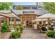 Exterior view of upscale retail and restaurant space with outdoor dining, surrounded by lush greenery at 635 Broadview Ne Pl, Atlanta, GA 30324
