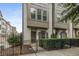 Charming painted brick townhome with iron fence and manicured landscaping at 635 Broadview Ne Pl, Atlanta, GA 30324