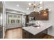 Stylish kitchen with stainless steel appliances, marble countertops, wood cabinets, and modern light fixture at 635 Broadview Ne Pl, Atlanta, GA 30324