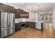 Modern kitchen featuring stainless steel appliances, wooden cabinets, marble countertops, and an open layout at 635 Broadview Ne Pl, Atlanta, GA 30324