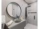 This bathroom includes a modern gray vanity with a frameless shower and gray tile at 8610 Sentinae Chase Dr, Roswell, GA 30076