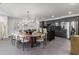 Chic dining room featuring a large table, modern chandelier, and sleek gray cabinets at 8610 Sentinae Chase Dr, Roswell, GA 30076