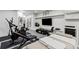 Well-appointed home gym features modern exercise equipment, a massage table, and sleek finishes at 8610 Sentinae Chase Dr, Roswell, GA 30076