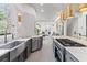 A modern kitchen is showcasing the large island with a gas cooktop and bar stool seating at 8610 Sentinae Chase Dr, Roswell, GA 30076