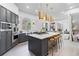 Bright, spacious kitchen with a center island, stainless appliances, gray cabinets, and pendant lighting at 8610 Sentinae Chase Dr, Roswell, GA 30076
