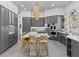 Modern kitchen with gray cabinetry, a large island, gold accents, and stainless steel appliances at 8610 Sentinae Chase Dr, Roswell, GA 30076