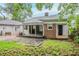 Exterior view of the home highlighting the backyard, screened in porch and brick accents at 1615 Stokes Sw Ave, Atlanta, GA 30310