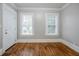 A bright bedroom features hardwood floors, two windows, and neutral paint at 1615 Stokes Sw Ave, Atlanta, GA 30310