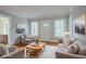 A staged living room with hardwood floors, natural paint, and bright sunlight at 1615 Stokes Sw Ave, Atlanta, GA 30310