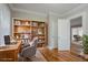 Office space with hardwood floors and built-in bookcase and view into another room at 1615 Stokes Sw Ave, Atlanta, GA 30310