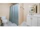 Bathroom with a blue shower curtain, toilet, marble floors and vanity at 1898 Alcovy Shoals Se Blf, Lawrenceville, GA 30045