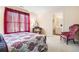 Cozy bedroom with red curtains, vintage furniture, and a glimpse into the en-suite bathroom at 1898 Alcovy Shoals Se Blf, Lawrenceville, GA 30045