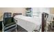 Comfortable bedroom featuring a hospital bed with white bedding and an adjacent wheelchair at 1898 Alcovy Shoals Se Blf, Lawrenceville, GA 30045