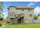 Rear view of a two-story home with a large deck and well-manicured lawn at 1898 Alcovy Shoals Se Blf, Lawrenceville, GA 30045