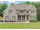 Charming two-story brick home with a well-manicured lawn and inviting front porch at 1898 Alcovy Shoals Se Blf, Lawrenceville, GA 30045