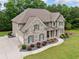 A beautiful home featuring a spacious driveway and well-maintained landscaping at 1898 Alcovy Shoals Se Blf, Lawrenceville, GA 30045