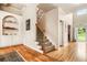 Grand foyer with hardwood floors, staircase, and built-in shelving for storage and decor at 1898 Alcovy Shoals Se Blf, Lawrenceville, GA 30045