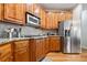 Modern kitchen with granite countertops, stainless appliances, and custom wood cabinetry at 1898 Alcovy Shoals Se Blf, Lawrenceville, GA 30045