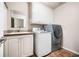 A functional laundry room equipped with modern washer, dryer, and extra storage space at 1898 Alcovy Shoals Se Blf, Lawrenceville, GA 30045