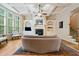 Bright living room with a fireplace, custom built-ins, and backyard view at 1898 Alcovy Shoals Se Blf, Lawrenceville, GA 30045