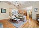 Inviting living room with coffered ceilings, hardwood floors, and a seamless flow to the kitchen at 1898 Alcovy Shoals Se Blf, Lawrenceville, GA 30045