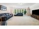 Spacious living room features large windows, plush seating, and a modern entertainment center at 1898 Alcovy Shoals Se Blf, Lawrenceville, GA 30045