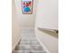 Carpeted staircase with a handrail, leading to another level of the house at 1898 Alcovy Shoals Se Blf, Lawrenceville, GA 30045