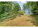 Expansive backyard featuring lush green grass, mature trees, and a swing set at 2395 Holly Branch Dr, Cumming, GA 30040