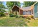 Exterior backyard showcases blooming flowers, blue siding, and lush green lawn at 2395 Holly Branch Dr, Cumming, GA 30040