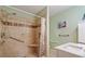 Accessible bathroom featuring a tiled shower, a shower bench, and grab bars at 2395 Holly Branch Dr, Cumming, GA 30040