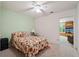 Comfortable bedroom featuring a ceiling fan and an adjacent sitting area with shelving at 2395 Holly Branch Dr, Cumming, GA 30040