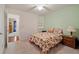Well-lit bedroom with carpet flooring, built-in shelving, and a view into another room at 2395 Holly Branch Dr, Cumming, GA 30040