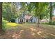 Inviting single-story home with mature trees providing shade and curb appeal at 2395 Holly Branch Dr, Cumming, GA 30040
