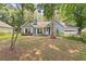 Charming single-story home with a lush front yard and attached two-car garage at 2395 Holly Branch Dr, Cumming, GA 30040